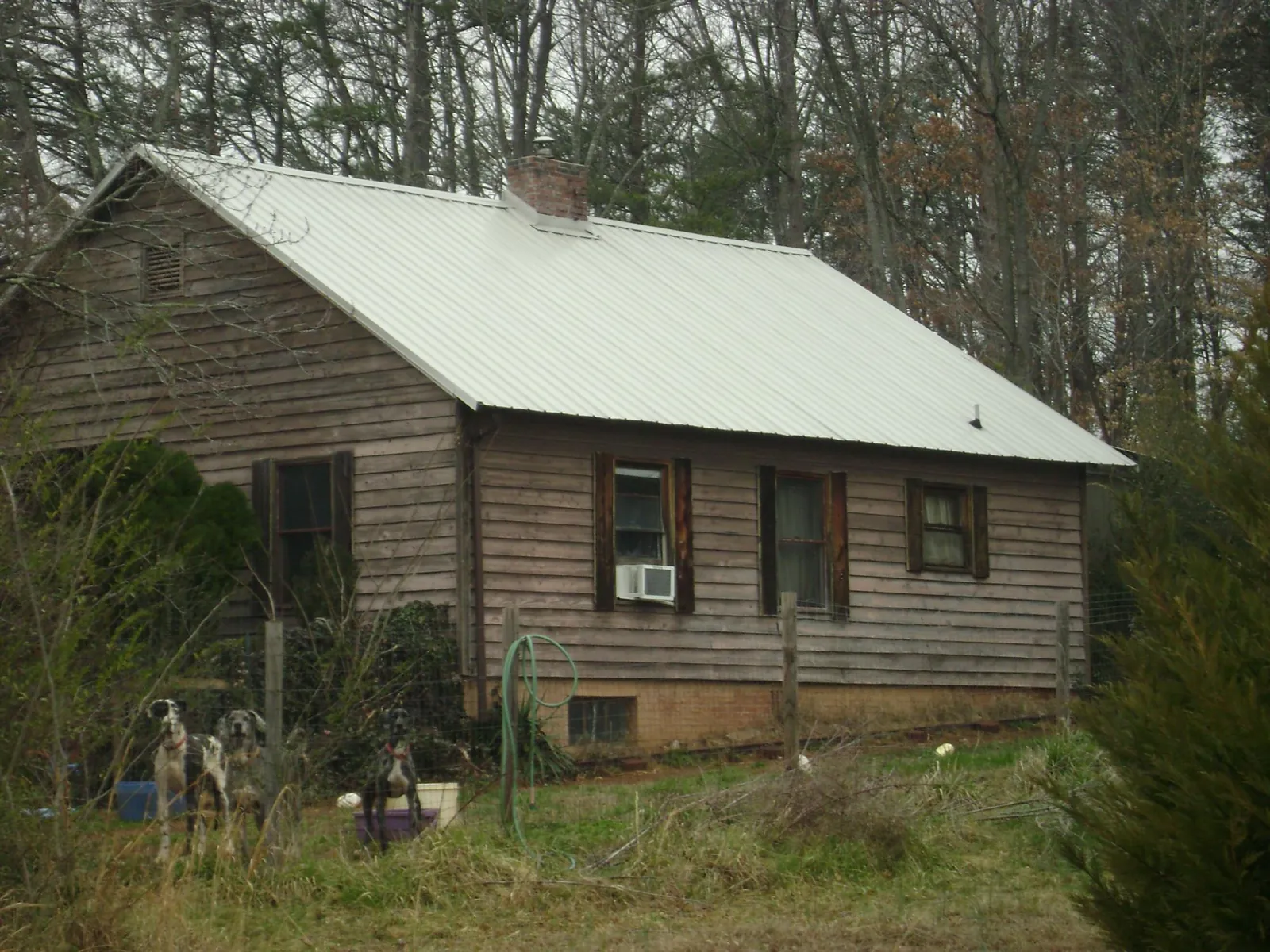 White metal roof on an old wood sided farmhouse, from a Metal Roof Installation job in Searcy